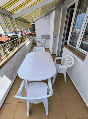 a white table and chairs on a balcony at Вила Катажина - Villa Katarzyna in Sozopol