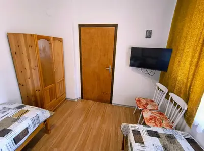 a room with two beds and a flat screen tv at Вила Катажина - Villa Katarzyna in Sozopol