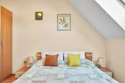 a bedroom with a bed with pillows on it at Charming 1-Bedroom Apartment in Ravda by Flat Mаnаger in Nesebar