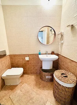 a bathroom with a sink and a toilet and a mirror at Seaside Oasis Apartment in Lozenets