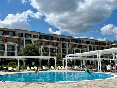a swimming pool in front of a large building at Apartment Premier Fort Beach hotel F1 420 in Sveti Vlas