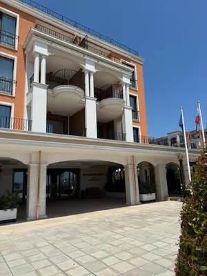 a large red brick building with a balcony at Apartment Premier Fort Beach hotel F1 420 in Sveti Vlas