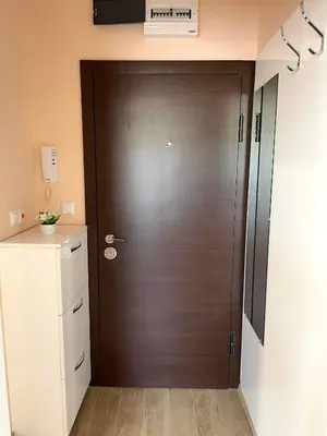 a brown door in a room with a white cabinet at Palms Studio in Sozopol, with free parking in Sozopol