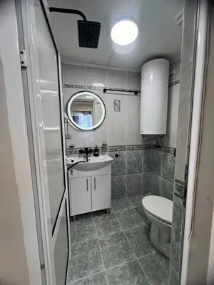 a small bathroom with a toilet and a sink at Varna central apartment with parking for normal to middle sized cars in Varna City