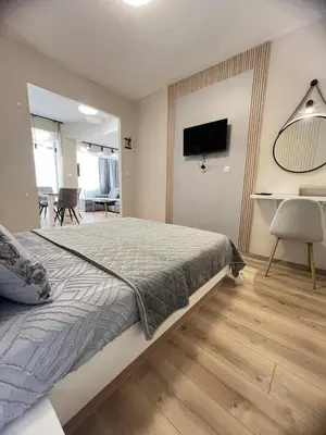 a bedroom with a bed and a living room at Varna central apartment with parking for normal to middle sized cars in Varna City
