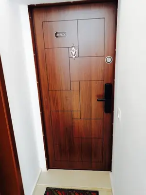 a wooden door in a hallway with a rug at Astell Superior Studio in Burgas City
