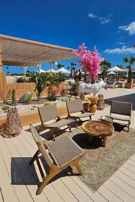 a deck with chairs and a table and a table and chairs at Апартамент Vip Vision Studio LUX in Sunny Beach