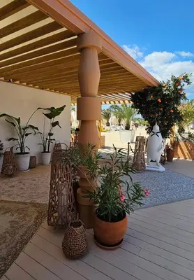 a patio with potted plants on a wooden deck at Апартамент Vip Vision Studio LUX in Sunny Beach