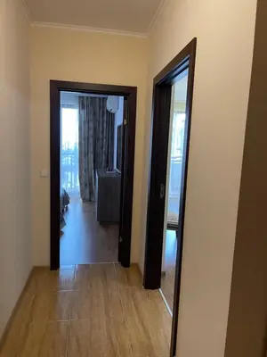 a view of a room with a mirror and a hallway at Apartment in Long Beach in Shkorpilovtsi