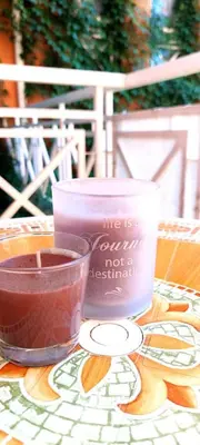 a table with a candle and a bowl of liquid at Studio in Sunny day 6 complex in Sunny Beach