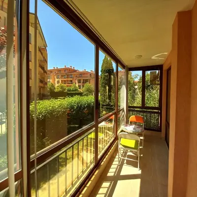 a balcony with windows and a view of the city at Star Dreams Apartment with Glass Veranda in Sveti Vlas
