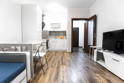 a living room with a kitchen and a dining room at HOT Main Square Newly Built Modern Apartment in Burgas City