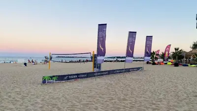 a volleyball court on a beach with the ocean at Bratanov Bahami Residence Studio in Sunny Beach