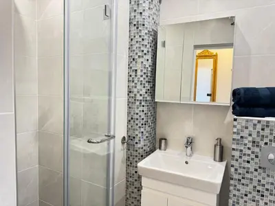 a bathroom with a sink and a shower at Luxus living in Burgas in Burgas City