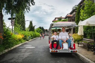a group of people riding in a golf cart down a street at 1 Apartment Verano Del Mar Sozopol in Sozopol