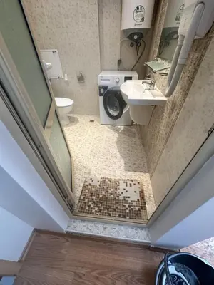 a small bathroom with a toilet and a sink at Apart Hotel Avalon in Sunny Beach