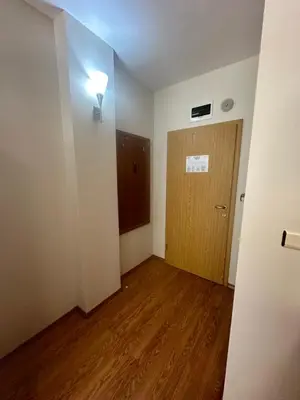 an empty room with a door and a wooden floor at Apart Hotel Avalon in Sunny Beach