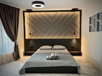 a bedroom with a bed with two shoes on it at South Bay Luxury Apartment in Varna City