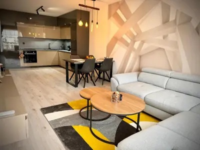 a living room with a couch and a table at South Bay Luxury Apartment in Varna City