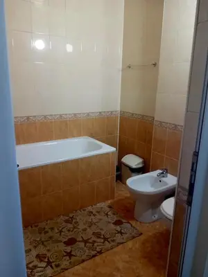 a bathroom with a tub and a toilet at Laura 2 in Primorsko