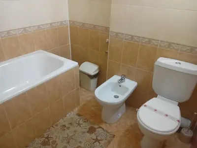 a bathroom with a toilet and a tub and a sink at Laura 2 in Primorsko