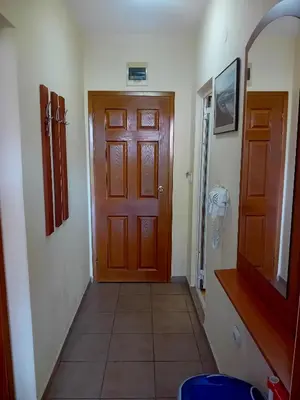 a hallway with a wooden door and a tile floor at Laura 2 in Primorsko