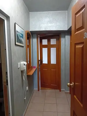 a hallway with a door and a phone on the wall at Laura 2 in Primorsko