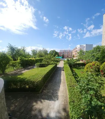 a walkway through a park in a city at Jolly apartments in Nesebar