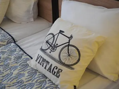 a drawing of a bike on a pillow on a bed at Jolly apartments in Nesebar