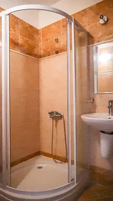 a bathroom with a shower and a sink at Jolly apartments in Nesebar