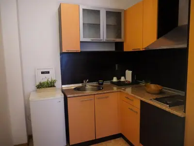 a small kitchen with a sink and a counter at Jolly apartments in Nesebar
