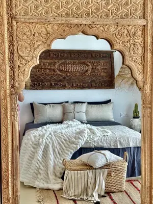 a bedroom with a large bed with an ornate headboard at Casa de oro Lujo in Sozopol