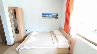 a small bed in a room with a window at Studio in the Center of Sunny Beach by Flat Mаnаger in Sunny Beach