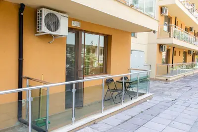 a balcony with a chair and an air conditioner on a building at Studio in the Center of Sunny Beach by Flat Mаnаger in Sunny Beach