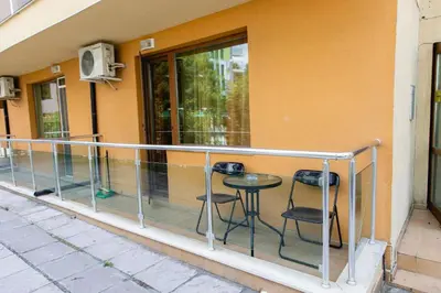 a balcony with two chairs and a table at Studio in the Center of Sunny Beach by Flat Mаnаger in Sunny Beach