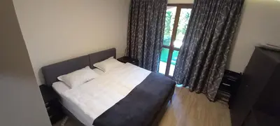 a bed with two pillows in a room with a window at Cascadas Victory Suite Ravda in Ravda