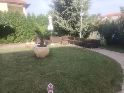 a garden with a potted plant in the grass at Cascadas Victory Suite Ravda in Ravda