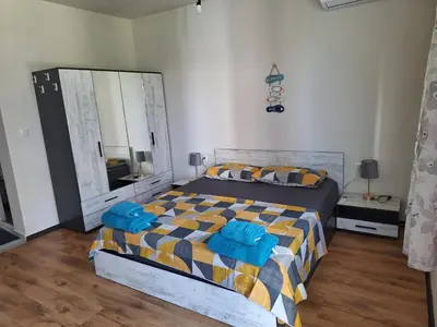 a bedroom with a bed and a large mirror at Studio Anelia in Sveti Vlas
