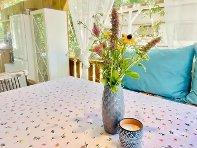 a vase of flowers sitting on a table at Каравана Безвремие in Chernomorets