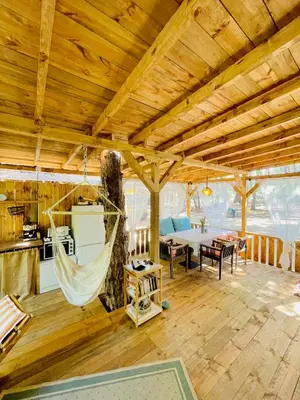 a room with a hammock in a wooden house at Каравана Безвремие in Chernomorets
