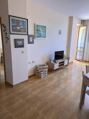 a living room with white walls and a wooden floor at the magic dream, Sveti Vlas in Sveti Vlas
