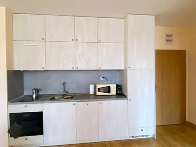 a kitchen with white cabinets and a microwave at the magic dream, Sveti Vlas in Sveti Vlas