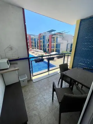 a room with a balcony with a view of a pool at Апартамент за нощувки в ЕЛИТ 4 Слънчев бряг in Sunny Beach