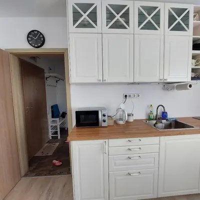 a kitchen with white cabinets and a microwave at Sun Holidays Byala in Byala