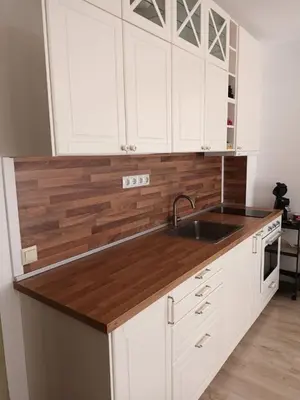 a kitchen with white cabinets and a wooden counter top at Sun Holidays Byala in Byala