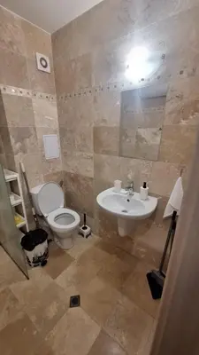 a bathroom with a toilet and a sink at Beachfront one bedroom apartment DIAMOND BEACH Burgas Sarafovo Студио в Diamond beach Сарафово in Burgas City