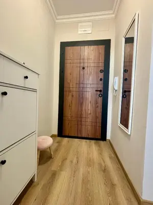 a room with a wooden door and a wooden floor at Triumph apartment in Burgas City