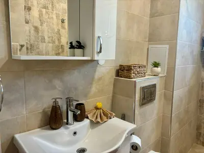 a bathroom with a sink and a mirror at Triumph apartment in Burgas City