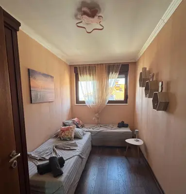 a small room with two beds and a window at Apartment Anastasia Santa Marina in Sozopol