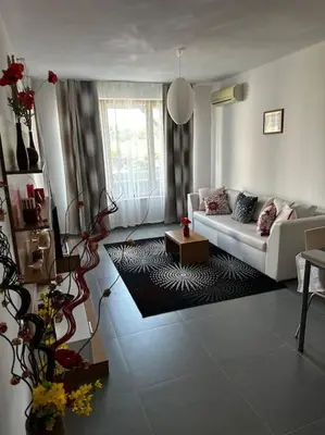 a living room with a couch and a table at Apartment in Paradise View complex in Sozopol